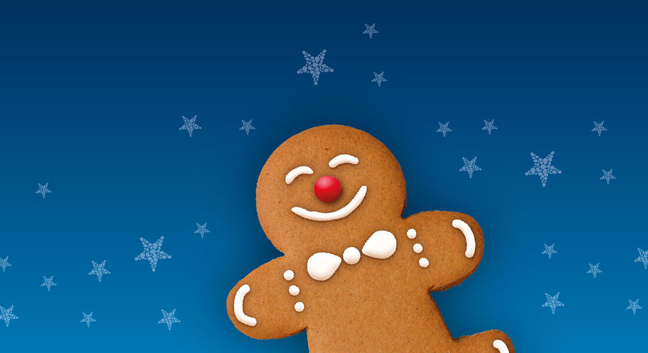 Lächender Lebkuchenmann mit Schneeflocken im Hintergrund.